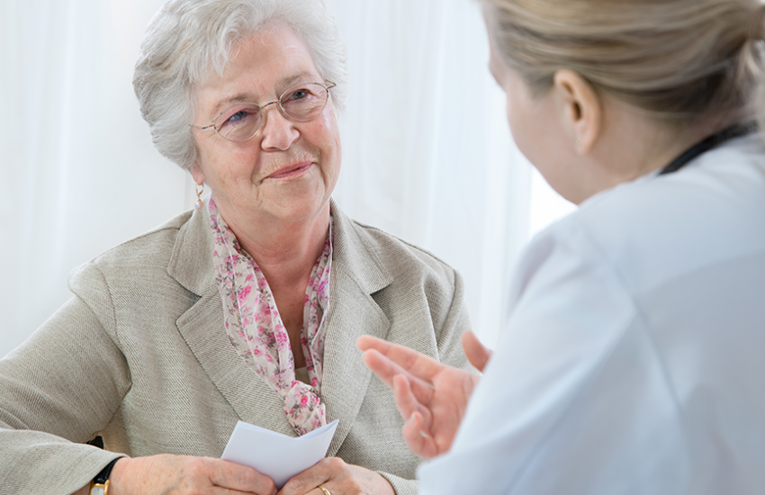 Senior woman speaking with doctor