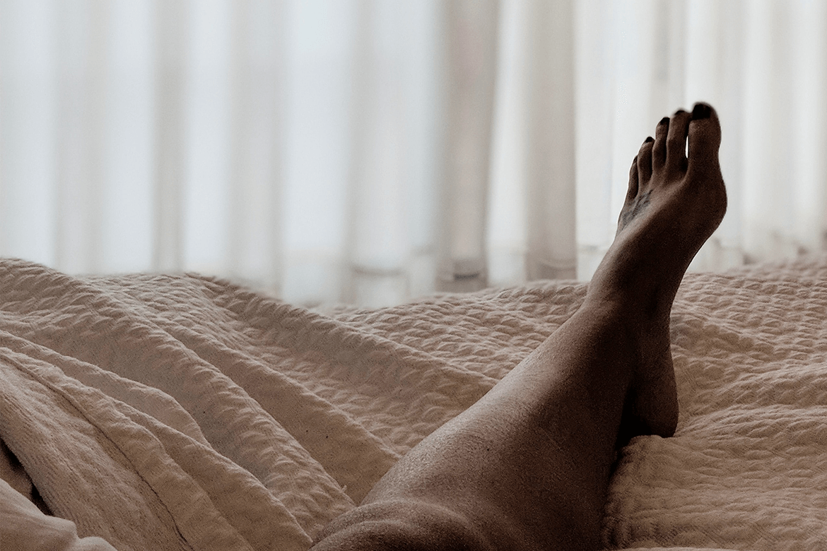 Woman's leg on bed