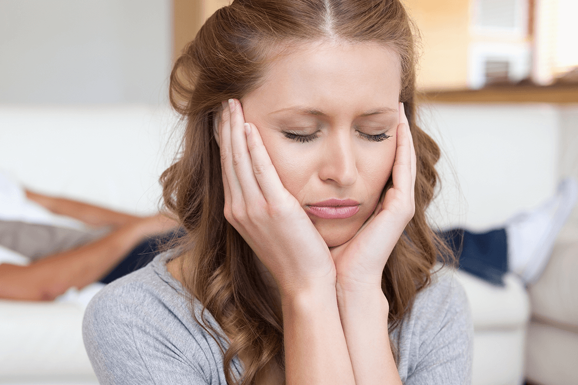 Stressed woman with hands on her head