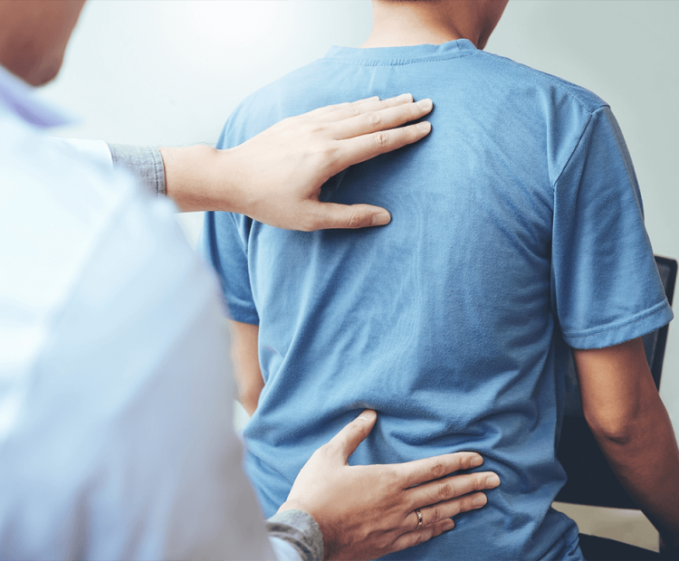 Doctor examining man's back