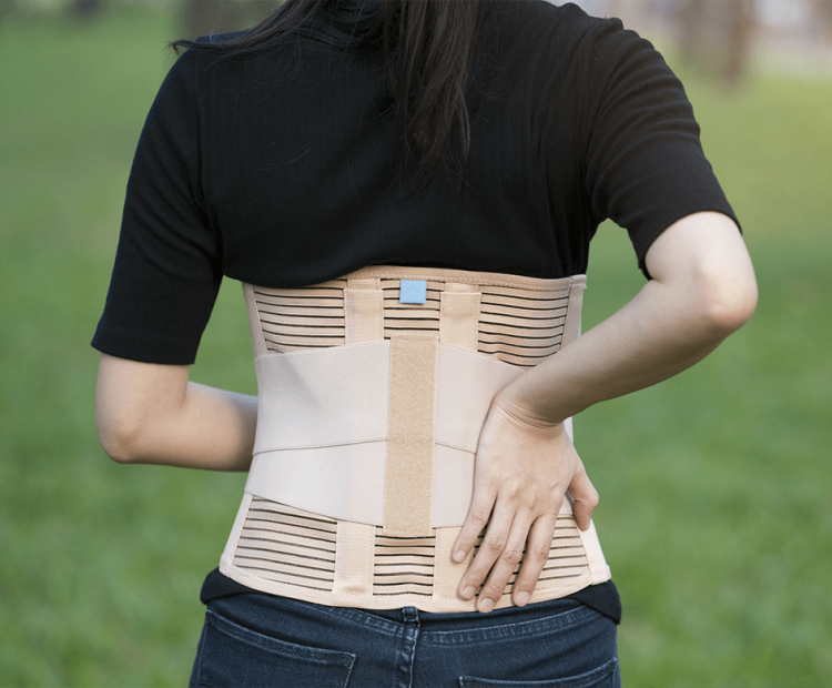 Woman wearing a lumbar-sacral orthosis brace