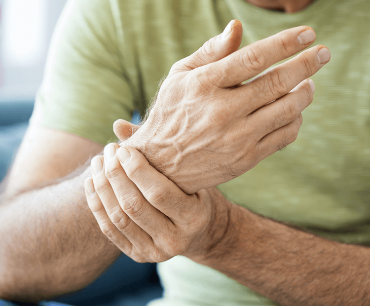 Man holding wrist in pain