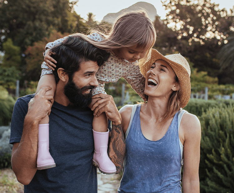 Young family with daughter on dad's back