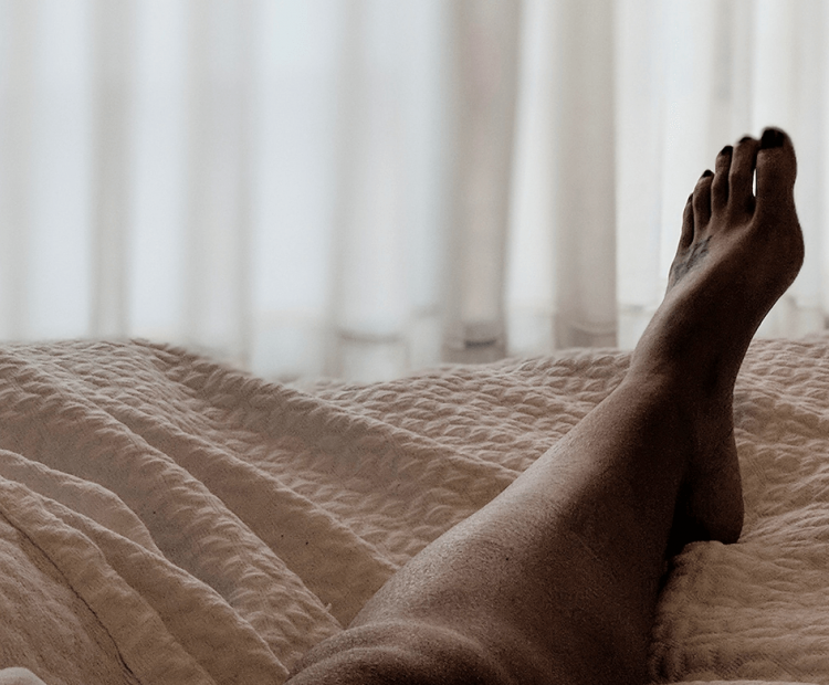 Woman's leg on bed