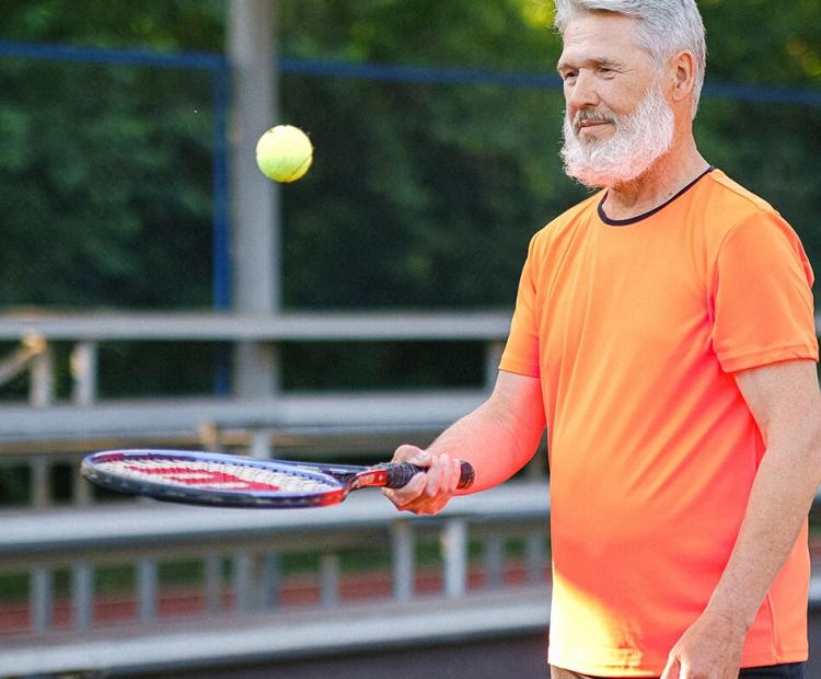 Man bouncing tennis ball on racket