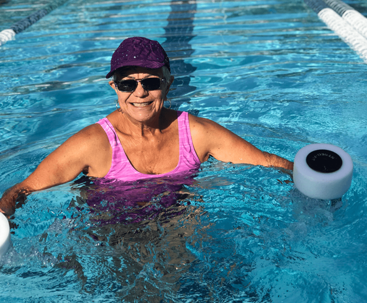 Senior woman exercising in pool