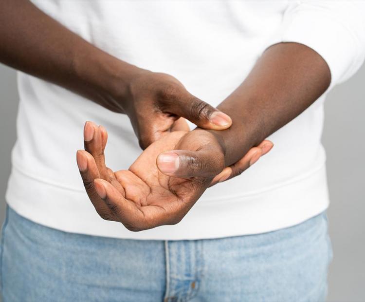 Man holding wrist in pain