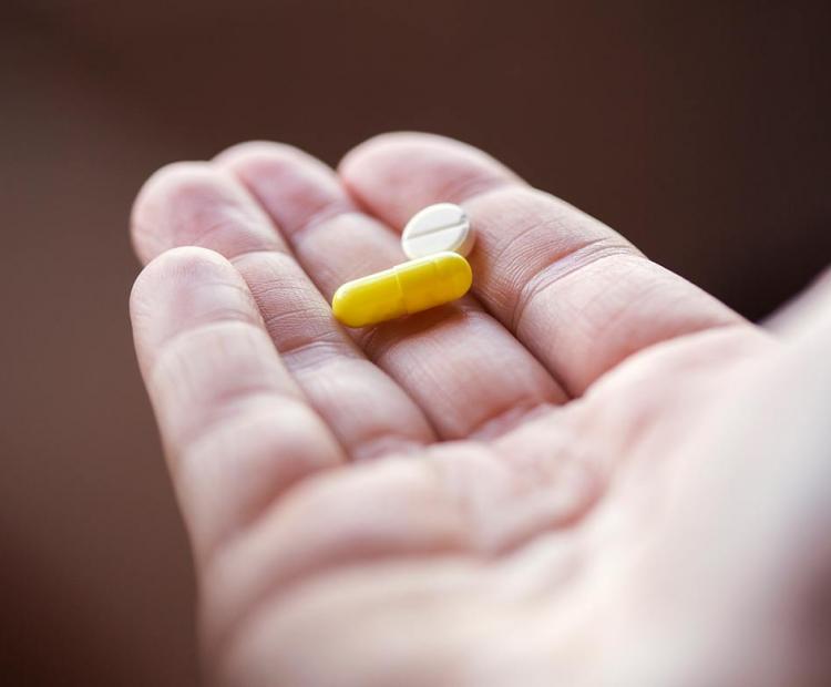 Hand holding pills