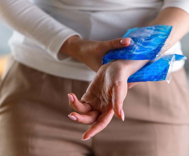 Woman with ice pack on her wrist