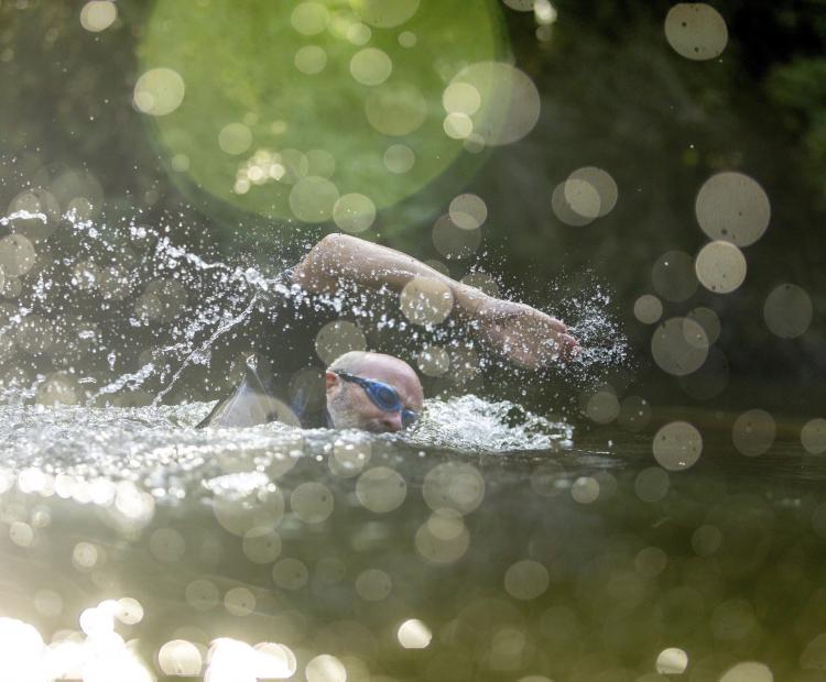 Image of many swimming without restrictions.
