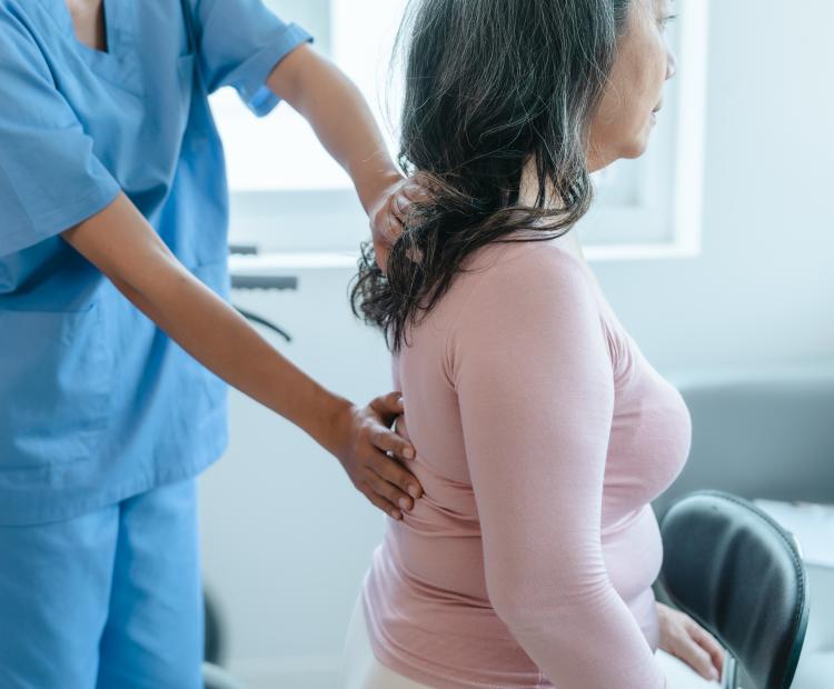 Woman having a back examination by a doctor.