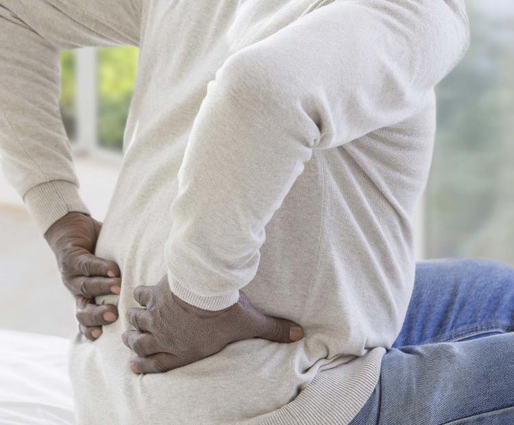 Man holding back in pain