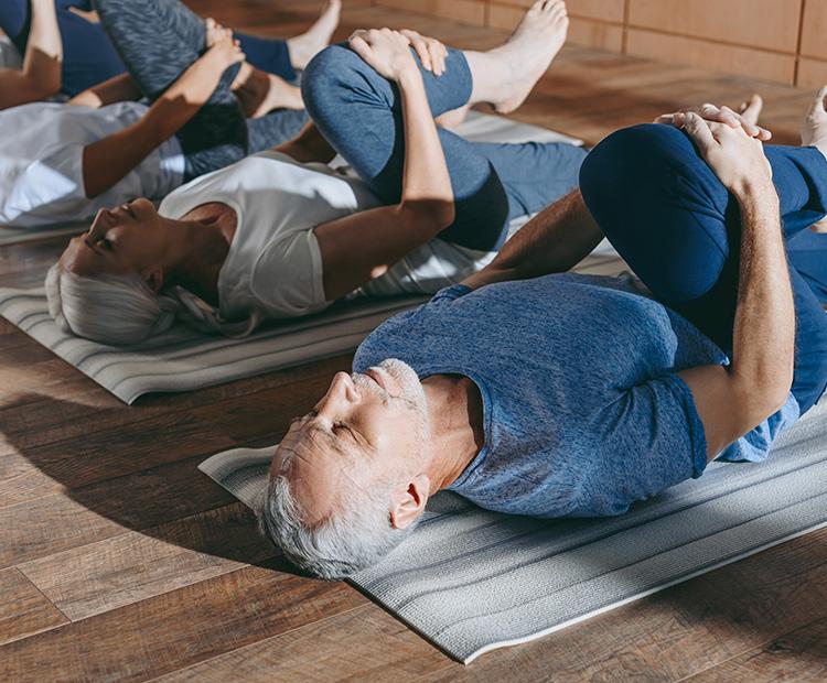 seniors stretching to relieve spinal stenosis pain