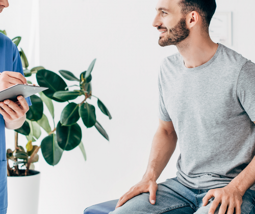 Man and doctor in exam room