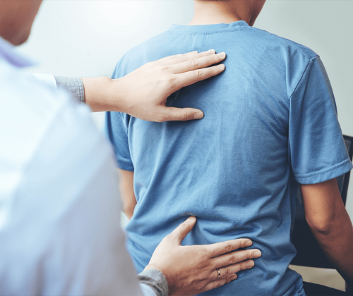 Doctor examining man's back