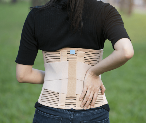 Woman wearing a lumbar-sacral orthosis brace
