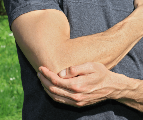 Man holding elbow in pain