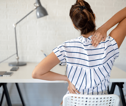 Woman with poor posture sitting at desk