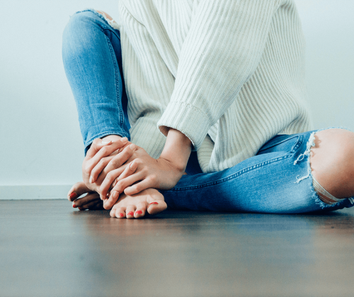 Woman holding her feet in pain