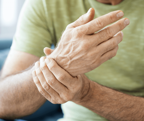 Man holding wrist in pain