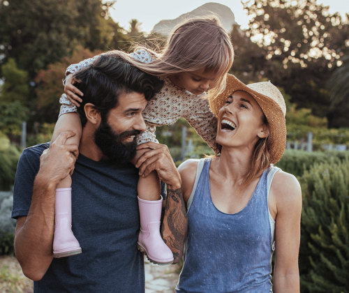 Young family with daughter on dad's back