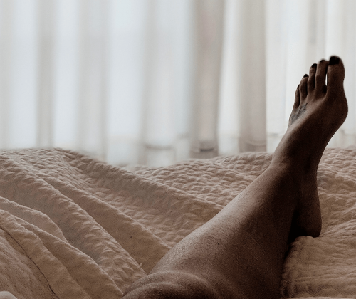 Woman's leg on bed