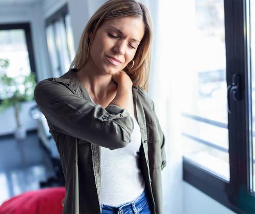 Woman rubbing neck in pain