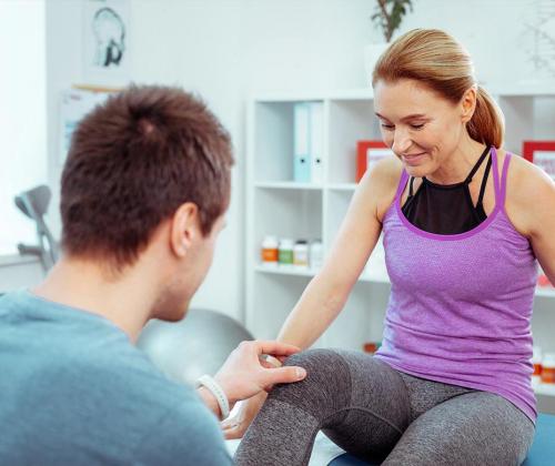 Woman at physical therapy table