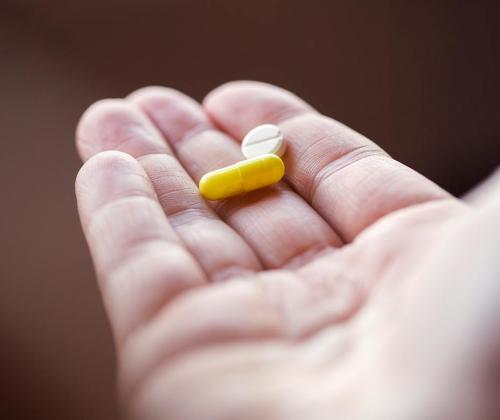Hand holding pills