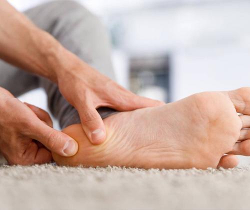 Man rubbing his foot