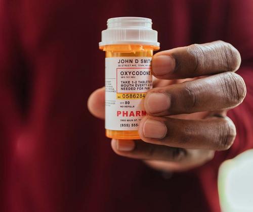 Man holding pill bottle