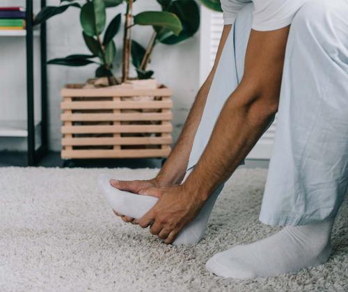 Man holding foot in pain