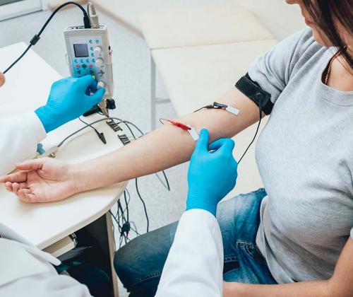 Woman receiving EMG nerve test on her arm