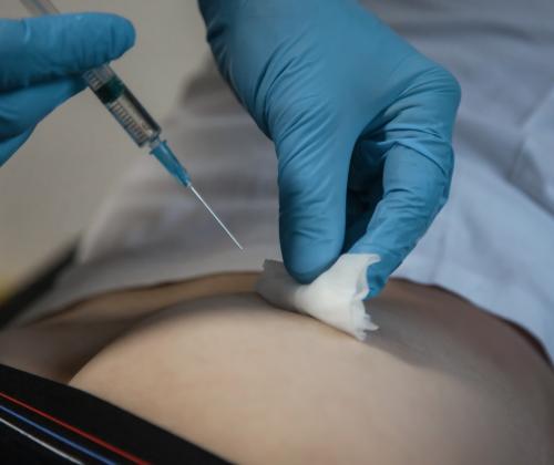 Image of a healthcare professional administering an injection.