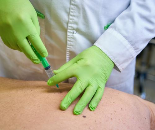 Image of person being injected in the back.