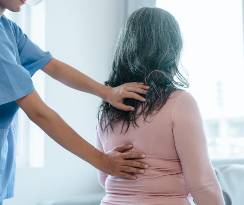 Woman having her back examined.