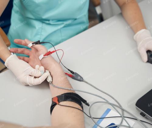 Healthcare professional conducting a diagnostic test on a patient using electrodiagnostic testing.