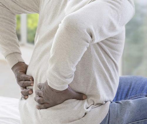 Man holding back in pain