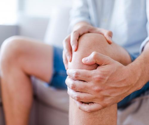 Man holding knee in pain