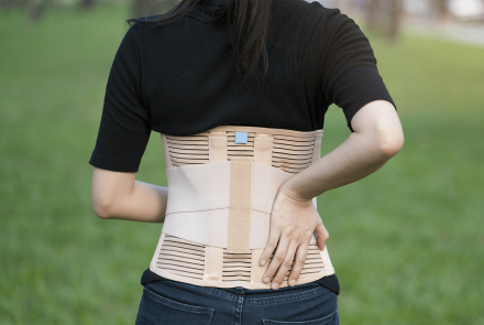 Woman wearing a lumbar-sacral orthosis brace