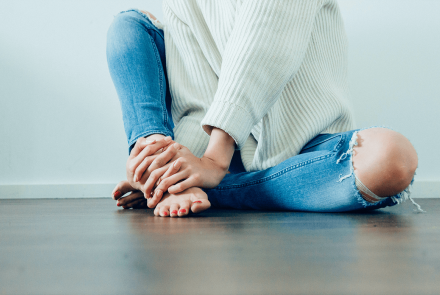 Woman holding her feet in pain