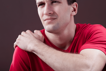 Man holding shoulder in pain