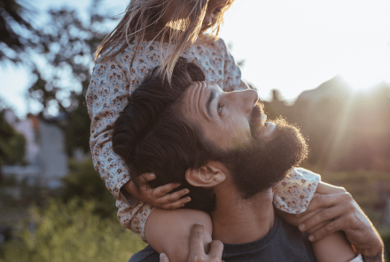 Man carrying daughter on shoulders