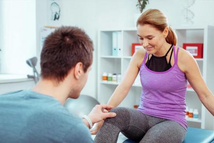 Woman at physical therapy table