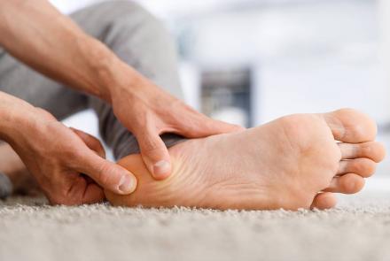 Man rubbing his foot