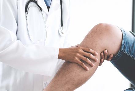 Doctor examining patient's knee