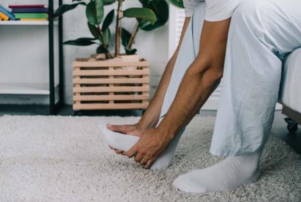 Man holding foot in pain