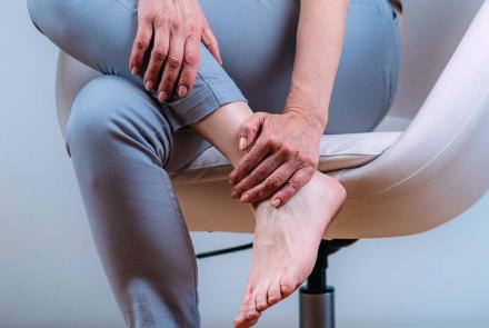 Woman with gout pain in ankle