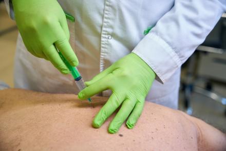 Image of person being injected in the back.