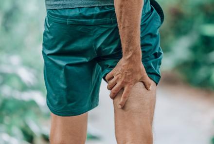 Man holding back of leg in pain